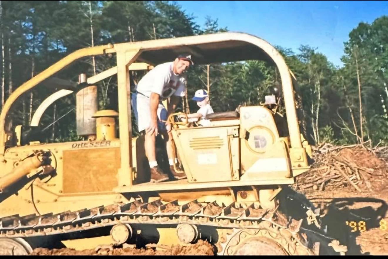 A father and young son on a Dresser dozer at a land clearing job, 1998