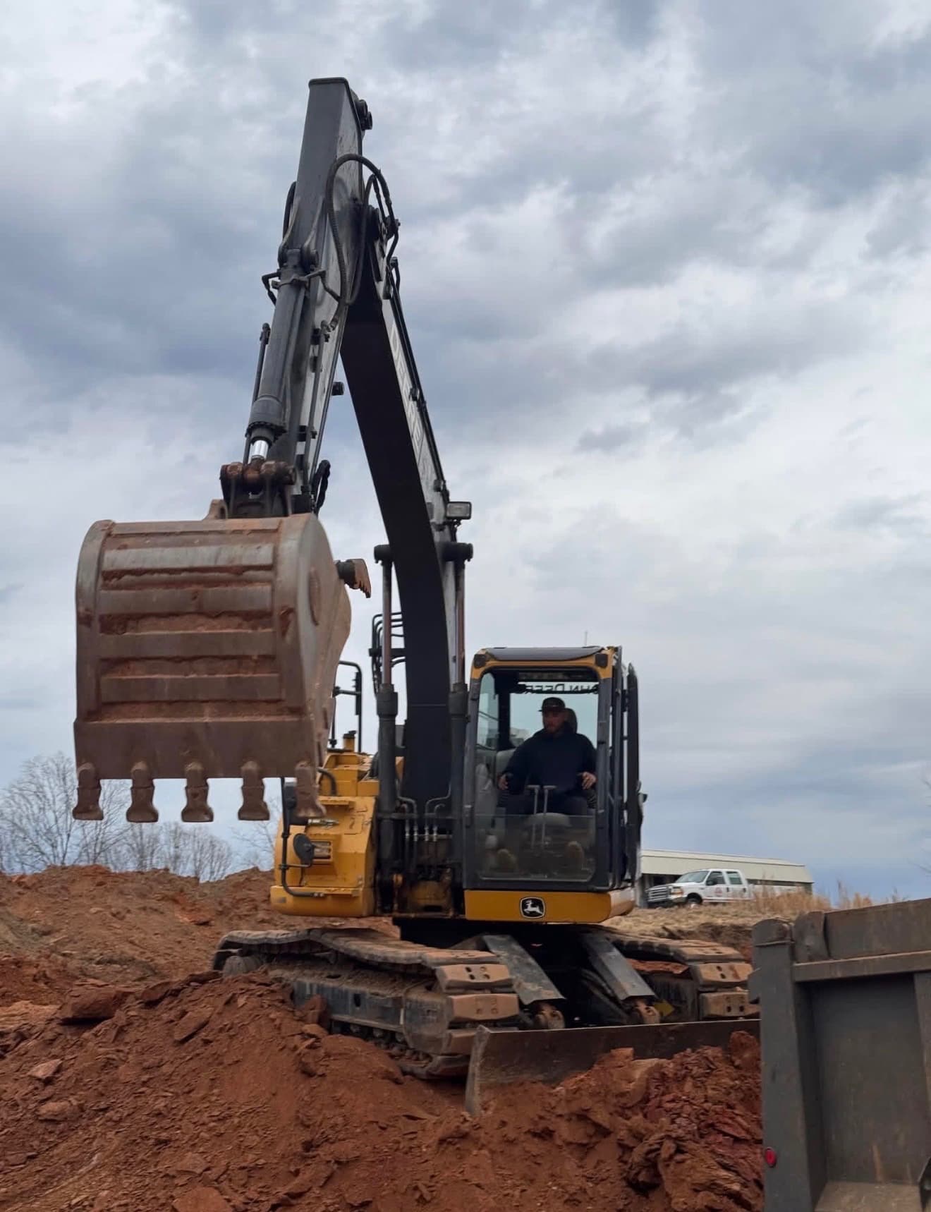 Tyler Jackson operating a John Deere excavator on a grading job