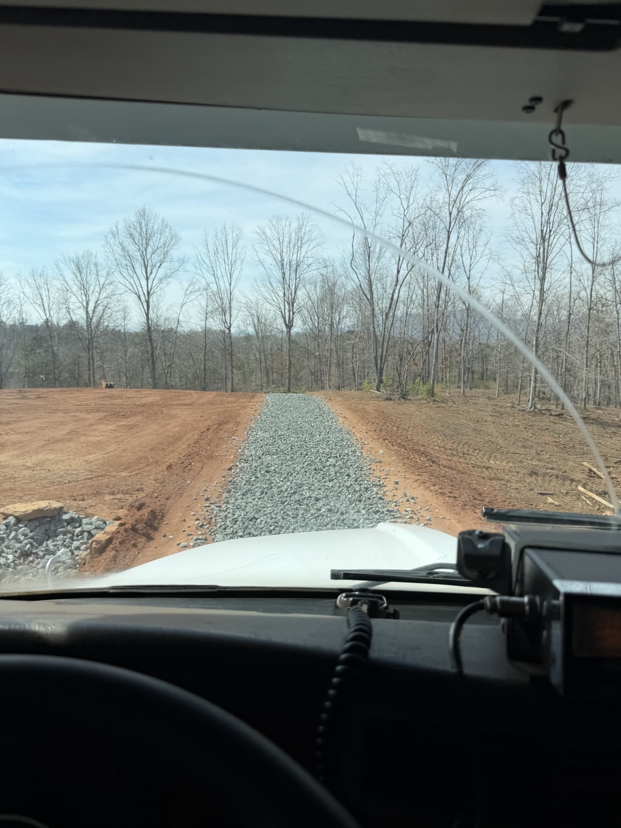Gravel spread down a drive, viewed from the truck