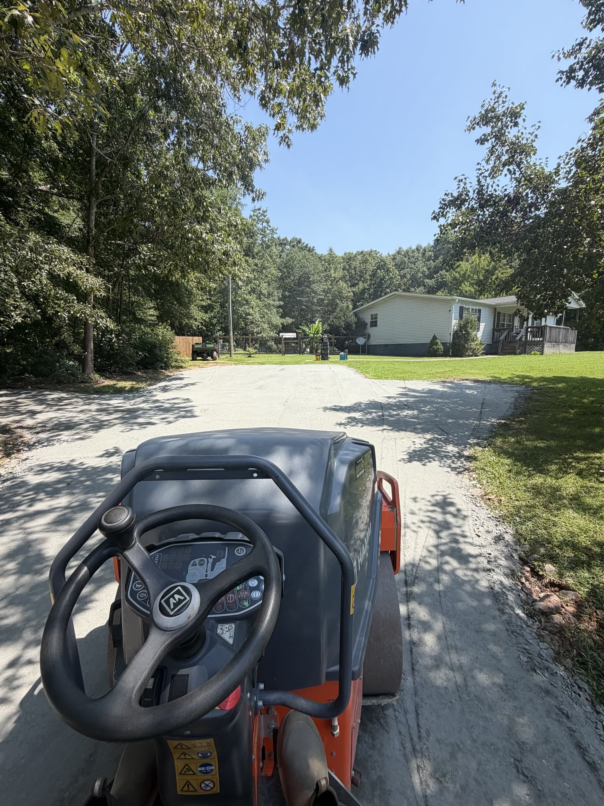 Roller packing a new gravel driveway