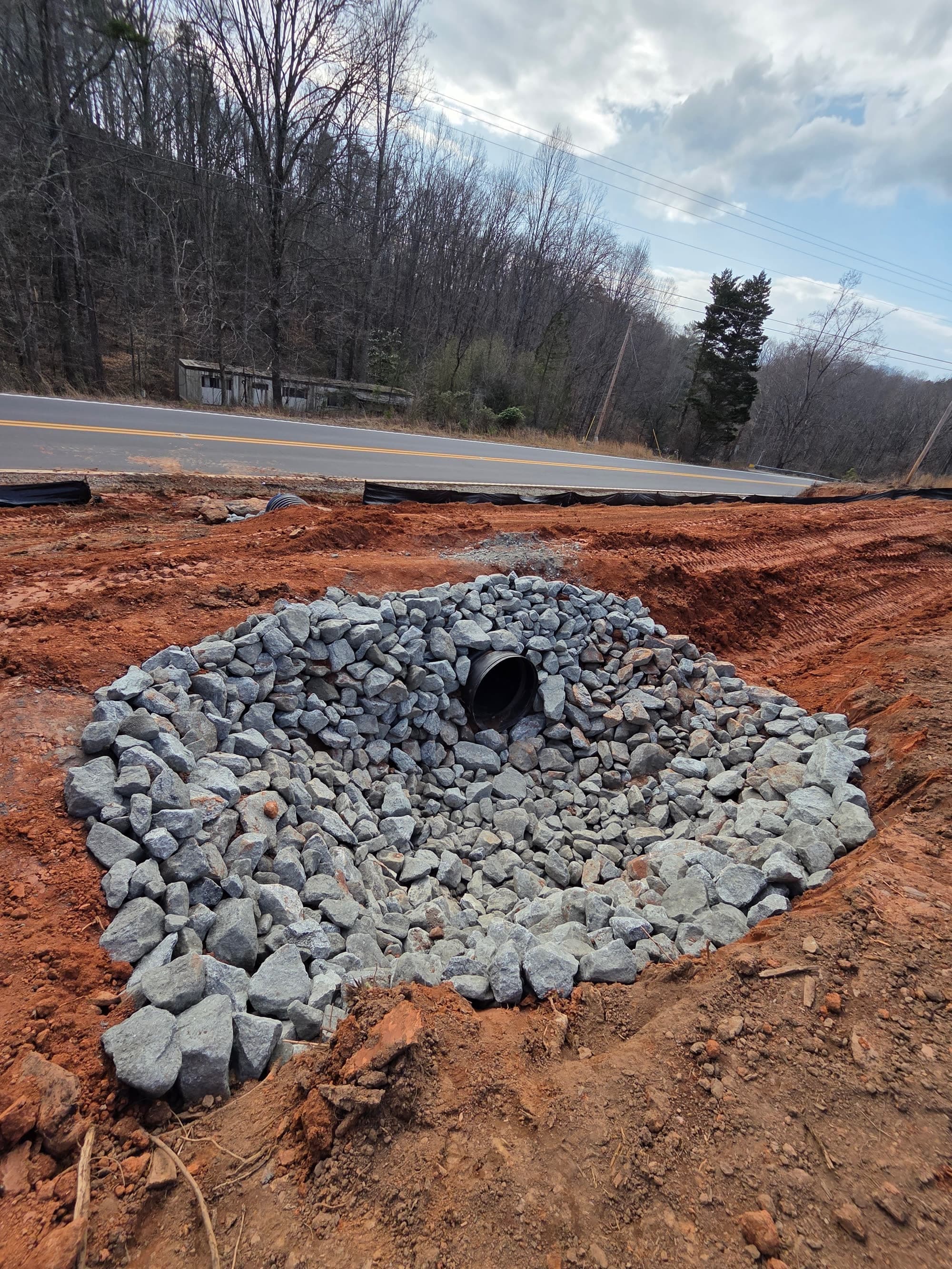 Finished culvert outlet with riprap and silt fence