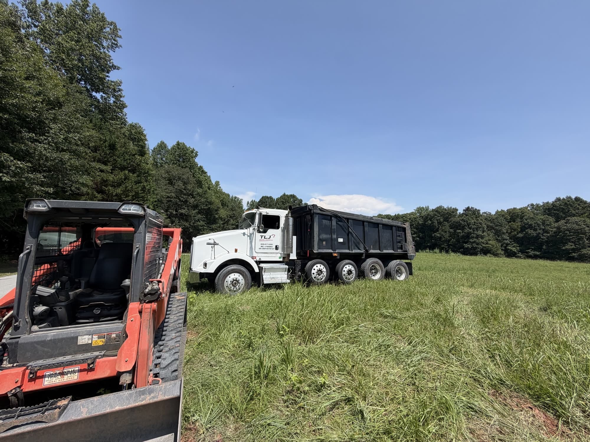 TLJ dump truck and track loader on a job in the field
