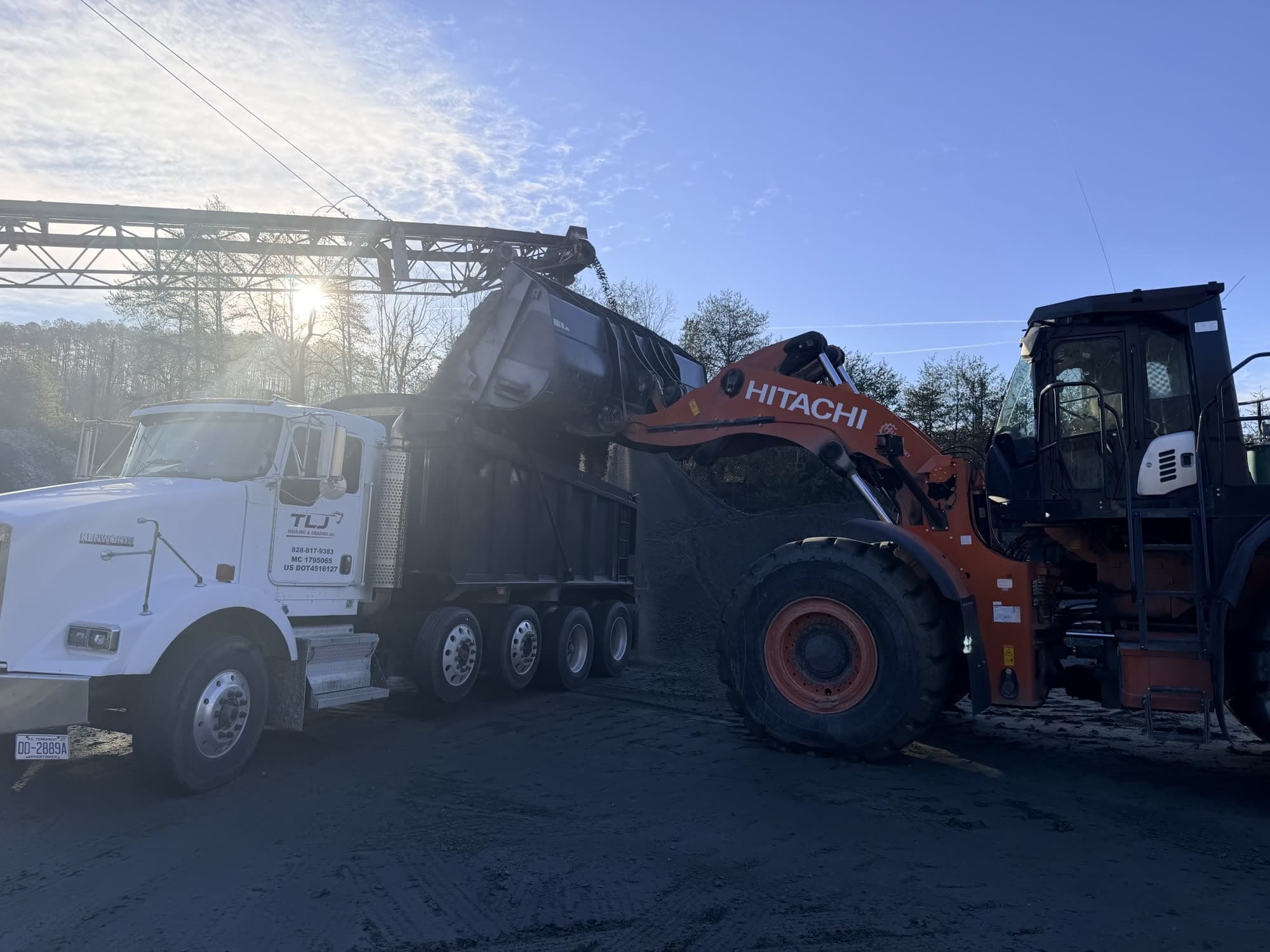 Loader filling the TLJ dump truck with material